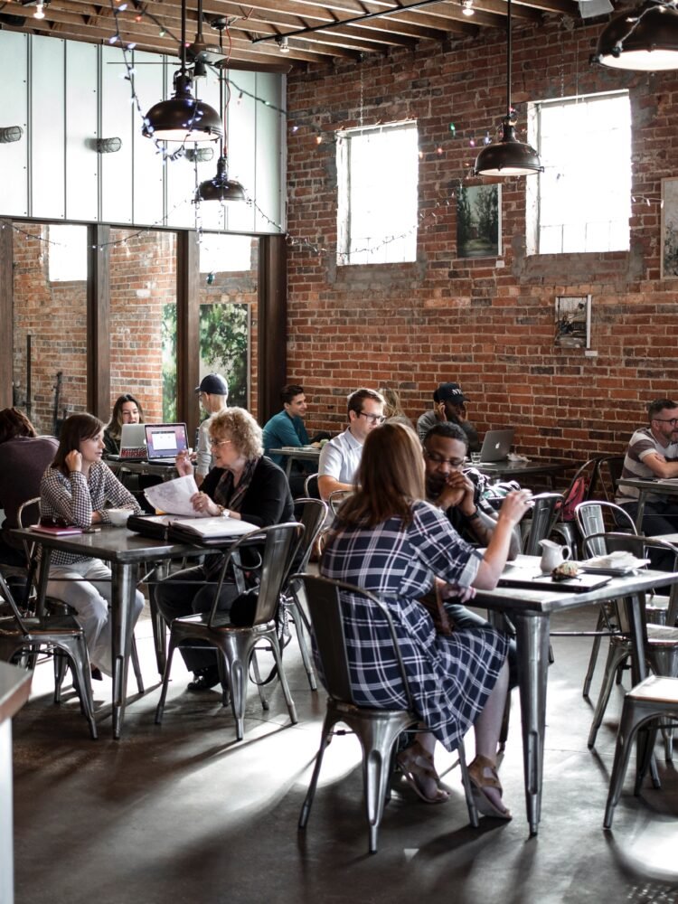 people sitting on restaurant chairs